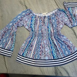 Tunic style shirt with an elasticized empire waist band
